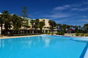 a large blue swimming pool in front of a building at Pestana Viking Beach & SPA Resort in Armação de Pêra