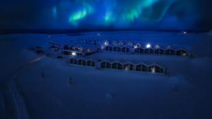 an aerial view of a hotel under the northern lights at night at Star Arctic Hotel & Activities in Saariselka