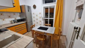 a small kitchen with a table and chairs in it at Apartment Justina in Staré Mesto +15 photos