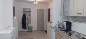 a kitchen with white cabinets and a counter top at Garsonieră la Anca Lupeni-Straja in Lupeni