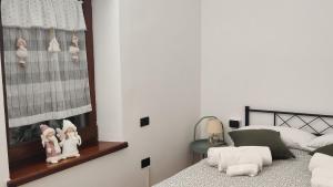 a bedroom with two beds and a mirror on the wall at La Casetta sotto la Torre in Lubriano