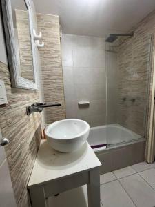 a bathroom with a bowl sink and a shower at Colibri MDQ in Mar del Plata