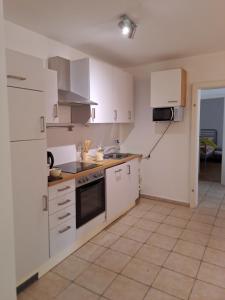 图尔恩Appartement Julis 1 in 3430 Tulln的厨房配有白色橱柜和炉灶烤箱