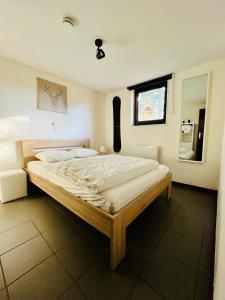 a bedroom with a large bed in a room at Maison des M in Houffalize