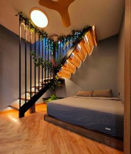 a bedroom with a bed and a staircase at Zen at Austin - Sleep 13 Pax-10 Min to Aeon Tebrau in Johor Bahru