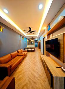 a living room with a couch and a tv at Zen at Austin - Sleep 13 Pax-10 Min to Aeon Tebrau in Johor Bahru