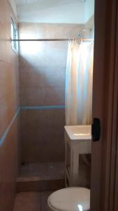 a bathroom with a shower and a toilet and a sink at Alquiler de Casa El Rulo in Miramar