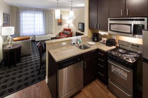a kitchen with a sink and a living room at TownePlace Suites by Marriott Little Rock West in Little Rock