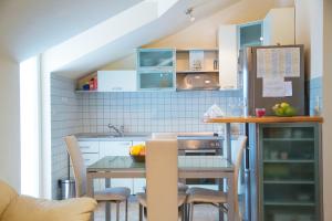 a kitchen with a table and chairs in a room at Apartment Aldo in Omiš