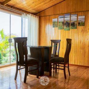 a dining room with a table and two chairs at Hotel Puerta Grande Mollendo Mejia in Mollendo
