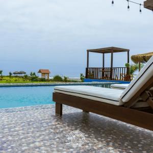 a mattress on a porch next to a swimming pool at Hotel Puerta Grande Mollendo Mejia in Mollendo