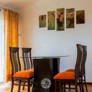 a dining room with a table and two chairs at Hotel Puerta Grande Mollendo Mejia in Mollendo +15 photos