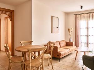 a living room with a couch and a table and chairs at Apartamentos Turísticos Casa de La Borrega in Estepona