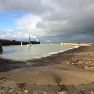 a sail boat in the water near a pier at LES FLOTS in Saint-Valery-en-Caux +4 photos