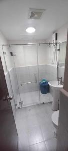 a bathroom with a shower and a toilet and a sink at 1 bedroom condominium in Lapu2x in Lapu Lapu City