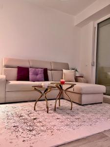 a living room with a couch and a coffee table at Mor Maison Skopje City-Center FEW FREE PRIVATE PARKING in Skopje
