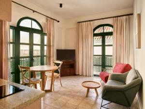 a living room with a table and chairs at Apartamentos Turísticos Casa de La Borrega in Estepona