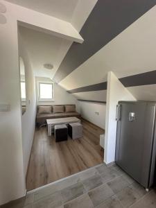 a living room with a couch and a table at Apartman Rim 