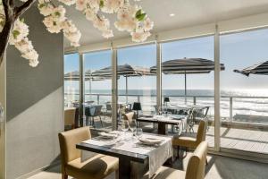 a restaurant with tables and chairs with a view of the ocean at Arribas Sintra Hotel in Sintra