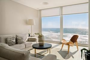 a living room with a view of the ocean at Arribas Sintra Hotel in Sintra