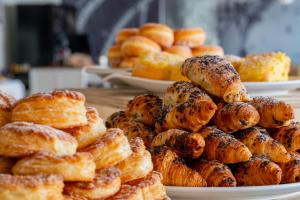 a pile of pastries on plates on a table at Arribas Sintra Hotel in Sintra