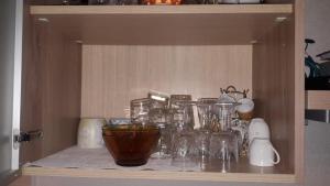 a shelf with glasses and other items on it at Mar Mar Appartaments in Briançon