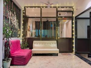 a living room with a couch and a chair at LD Guest House, Ayodhya in Ayodhya
