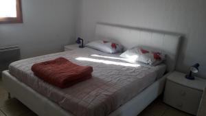 a bedroom with a bed with a red blanket on it at Mar Mar Appartaments in Briançon
