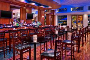 a bar with tables and chairs in a restaurant at The Westin Memphis Beale Street in Memphis