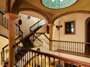 an spiral staircase in a home with a circular ceiling at Apartamentos Turísticos Casa de La Borrega in Estepona
