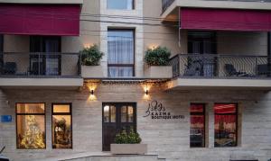 a building with a sign on the front of it at Kazma Boutique Hotel in Tbilisi City
