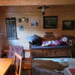 a room with a couch with pillows on it at Holzhütte allein am Waldrand in Saldenburg