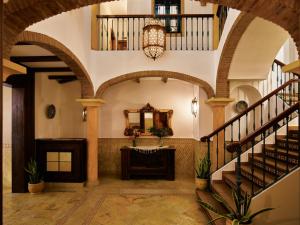 a lobby with a staircase and a mirror at Apartamentos Turísticos Casa de La Borrega in Estepona