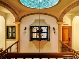 a building with a chandelier hanging from a ceiling at Apartamentos Turísticos Casa de La Borrega in Estepona