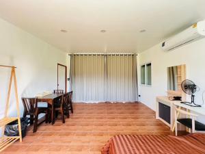 a living room with a dining room table and chairs at Sandy house Pai 2 in Pai +20 photos