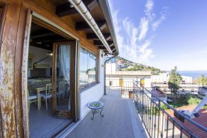a balcony with a table and a view of the ocean at Casa Vacanze Vista Mare in Castel di Tusa