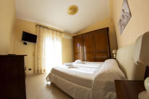 a bedroom with a bed and a large window at Casa Vacanze Vista Mare in Castel di Tusa