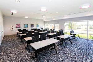 a conference room with tables and chairs and a large window at TownePlace Suites Port St. Lucie I-95 in Port Saint Lucie +23 photos