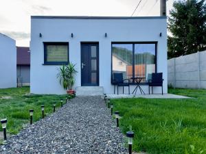 a white house with a pathway leading to it at Cozy Nest Rasnov in Râşnov