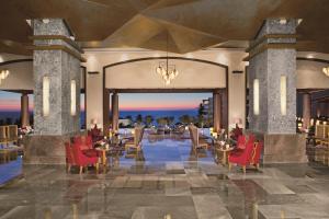 a rendering of a resort lobby with red chairs and tables at Secrets Vallarta Bay Resort & SPA - Adults Only in Puerto Vallarta