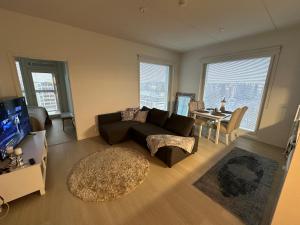 a living room with a couch and a table at Style 1BR with sauna&balcony in Vantaa
