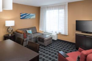 a living room with a couch and a tv at TownePlace Suites by Marriott Panama City in Panama City