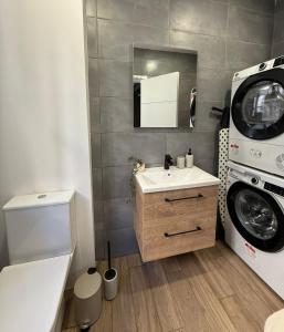 a bathroom with a washing machine and a sink at Iconic Suites Valletta in Valletta