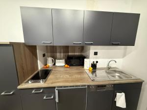 a kitchen with a sink and a counter top at Iconic Suites Valletta in Valletta +16 photos