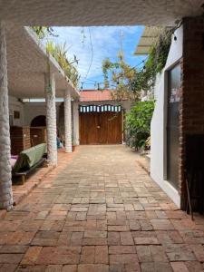 an empty courtyard of a house with a wooden door at Casa de Heidi in Puerto López +12 photos