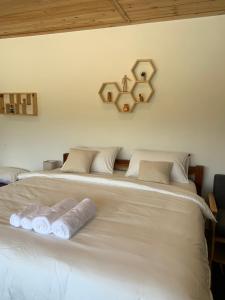 a bed with two towels on top of it at อาเลเล พูลวิลล่า ahlaylay pool villa in Ban Ku Phadu +9 photos