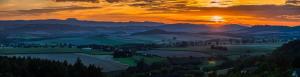 a sunset over a valley with fields and mountains at Agroturystyka u Janosika in Bozkow