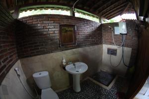 a small bathroom with a sink and a toilet at Omah Garengpoeng Guest House in Borobudur