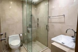 a bathroom with a shower and a toilet and a sink at Baan Mai Khao Condo Phuket for rent in Phuket +8 photos