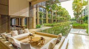 a hotel lobby with a view of a canal at Baan Mai Khao Condo Phuket for rent in Phuket